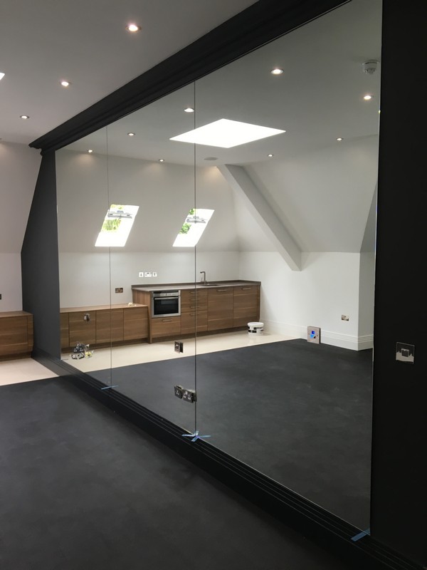 Frameless glass partition in loft conversion by Isleworth glaziers