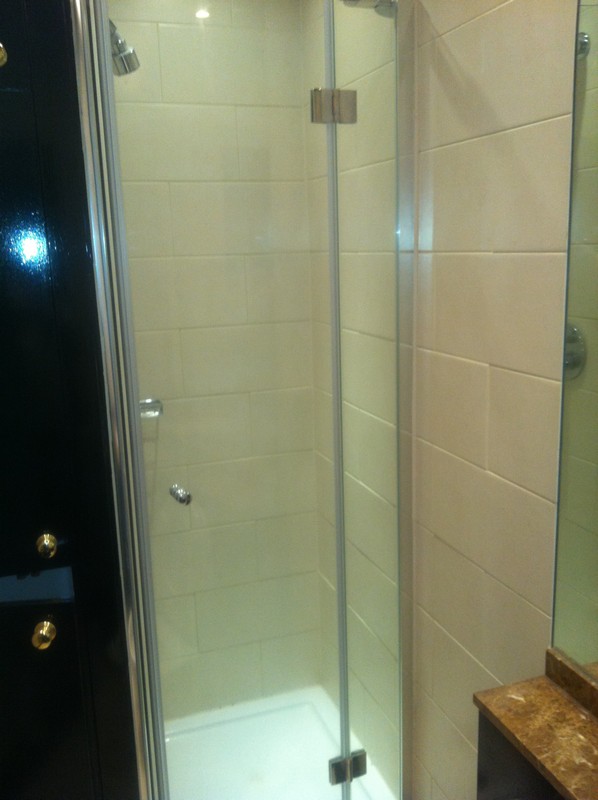 Frameless glass shower enclosure with chrome fittings in Isleworth