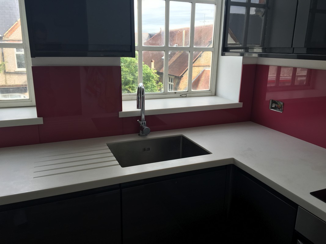 Deep plum coloured glass splashback in modern Isleworth kitchen